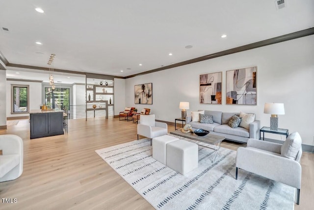 1312 Hunting Ridge Rd, Raleigh, NC 27615 - living area featuring ornamental molding, light wood finished floors, baseboards, and recessed lighting