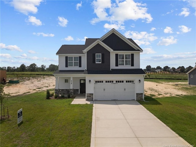 craftsman house with a garage and a front lawn