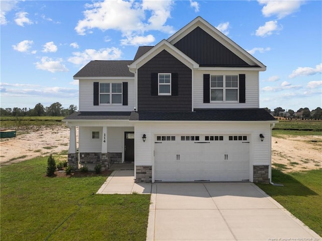 craftsman-style house with a garage, covered porch, and a front yard