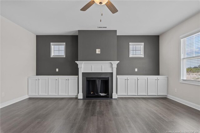 unfurnished living room featuring ceiling fan and hardwood / wood-style flooring