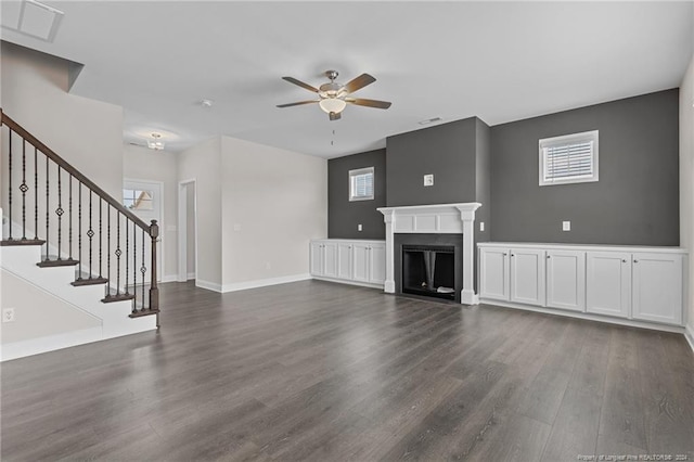 unfurnished living room featuring dark hardwood / wood-style flooring and ceiling fan