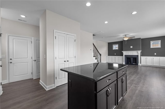 kitchen with a center island, dark wood-type flooring, and ceiling fan