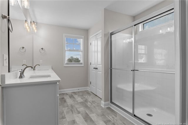 bathroom featuring vanity, plenty of natural light, and walk in shower