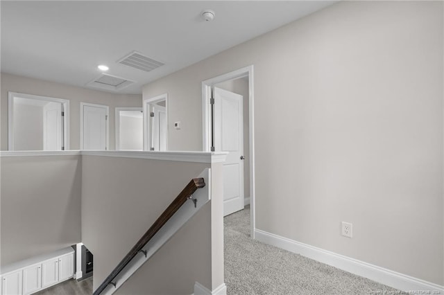 hallway featuring light colored carpet