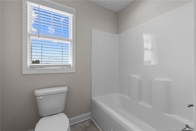 bathroom with tub / shower combination and toilet