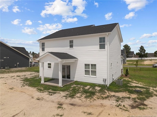 back of property with cooling unit and a patio area