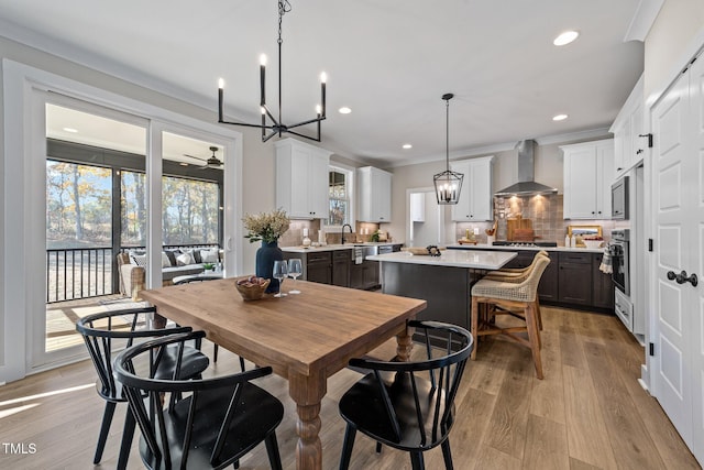 148 Hook Dr Lot 7, Fuquay Varina, NC 27526 - dining space with a chandelier, recessed lighting, light wood-style flooring, and crown molding