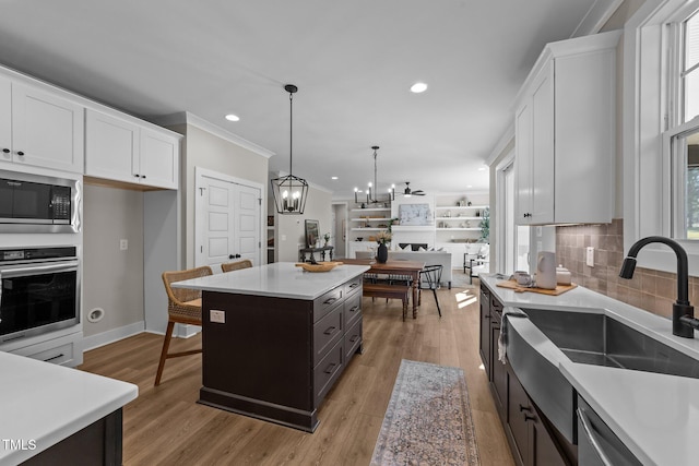 kitchen featuring a kitchen island, white cabinets, and appliances with stainless steel finishes