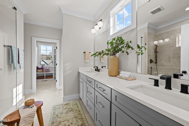 bathroom featuring ornamental molding, an enclosed shower, vanity, and a wealth of natural light