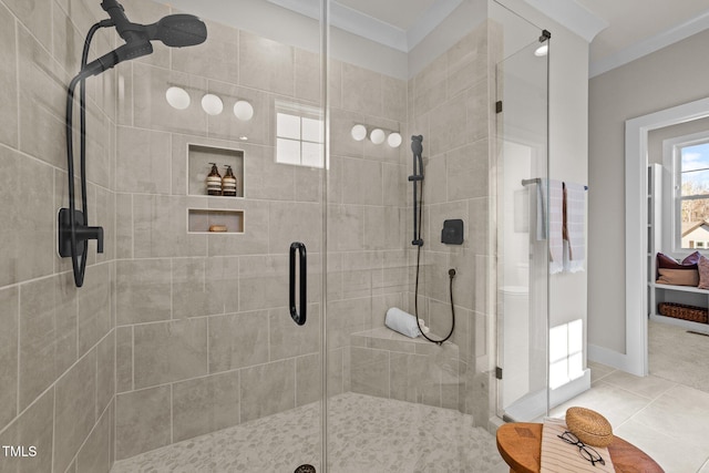 bathroom with tile patterned flooring, ornamental molding, and a shower with shower door