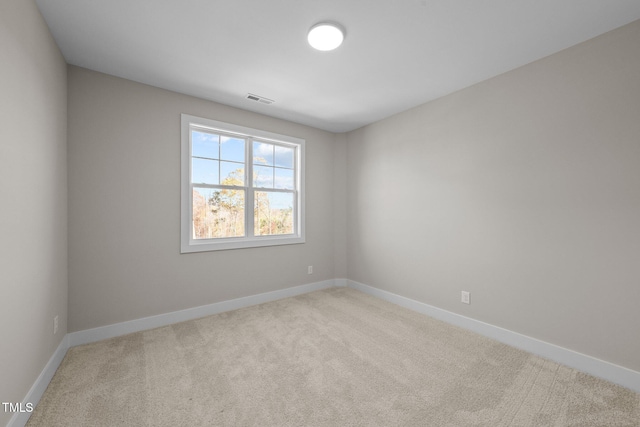 empty room featuring light colored carpet