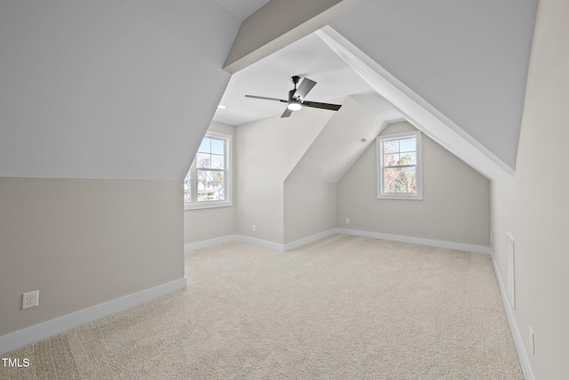 bonus room featuring vaulted ceiling, plenty of natural light, light carpet, and ceiling fan