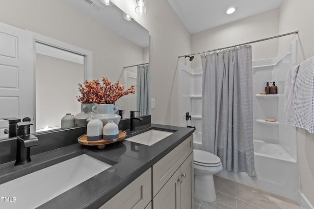 full bathroom featuring vanity, tile patterned floors, shower / bath combination with curtain, and toilet