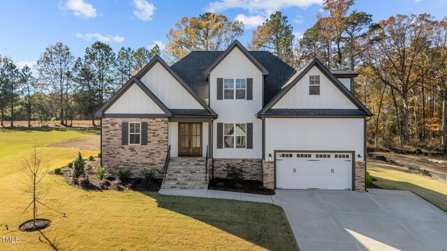 view of front of property featuring a garage and a front lawn