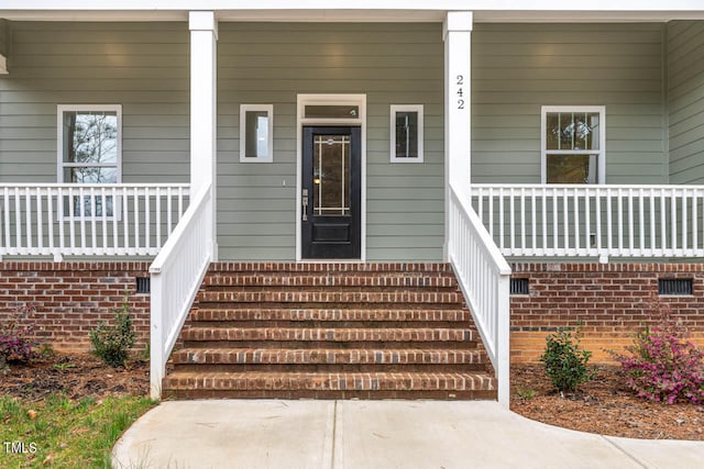 doorway to property featuring a porch