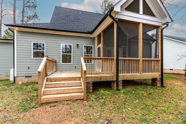 rear view of house featuring a deck and a sunroom