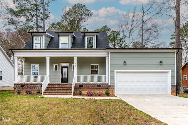 view of front of home featuring a front lawn, covered porch, and a garage