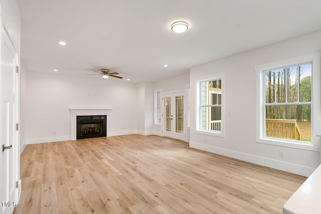 unfurnished living room with light hardwood / wood-style floors and ceiling fan