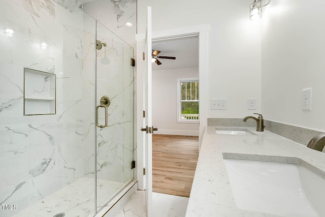 bathroom featuring an enclosed shower, ceiling fan, double sink vanity, and tile flooring