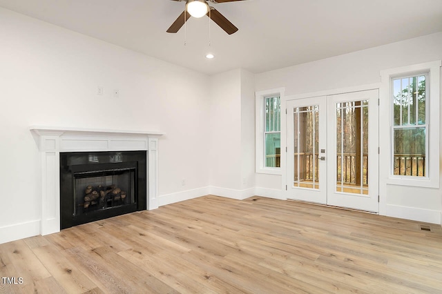 unfurnished living room featuring french doors, light hardwood / wood-style floors, and ceiling fan