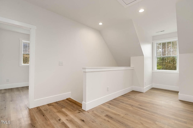 bonus room featuring lofted ceiling and light hardwood / wood-style floors