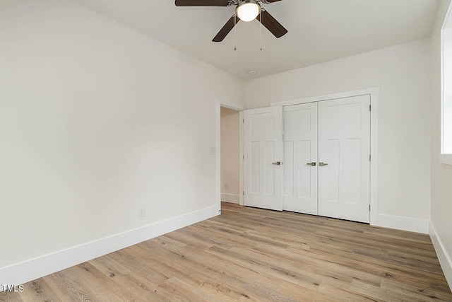 unfurnished bedroom featuring a closet, ceiling fan, and light wood-type flooring