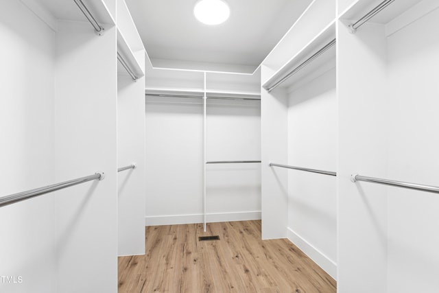 spacious closet featuring light hardwood / wood-style flooring