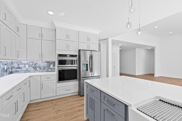 kitchen featuring white cabinets, backsplash, and appliances with stainless steel finishes