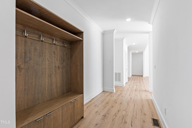 mudroom featuring light hardwood / wood-style flooring and ornamental molding