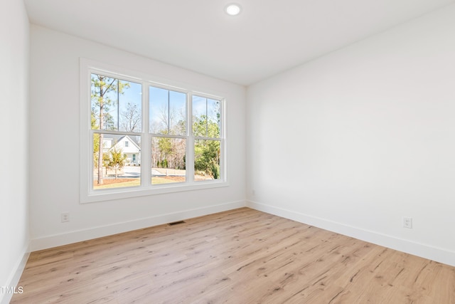 spare room featuring light hardwood / wood-style flooring