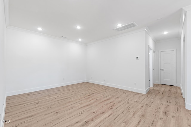 unfurnished room featuring ornamental molding and light wood-type flooring