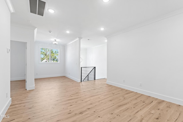 spare room with crown molding and light hardwood / wood-style flooring