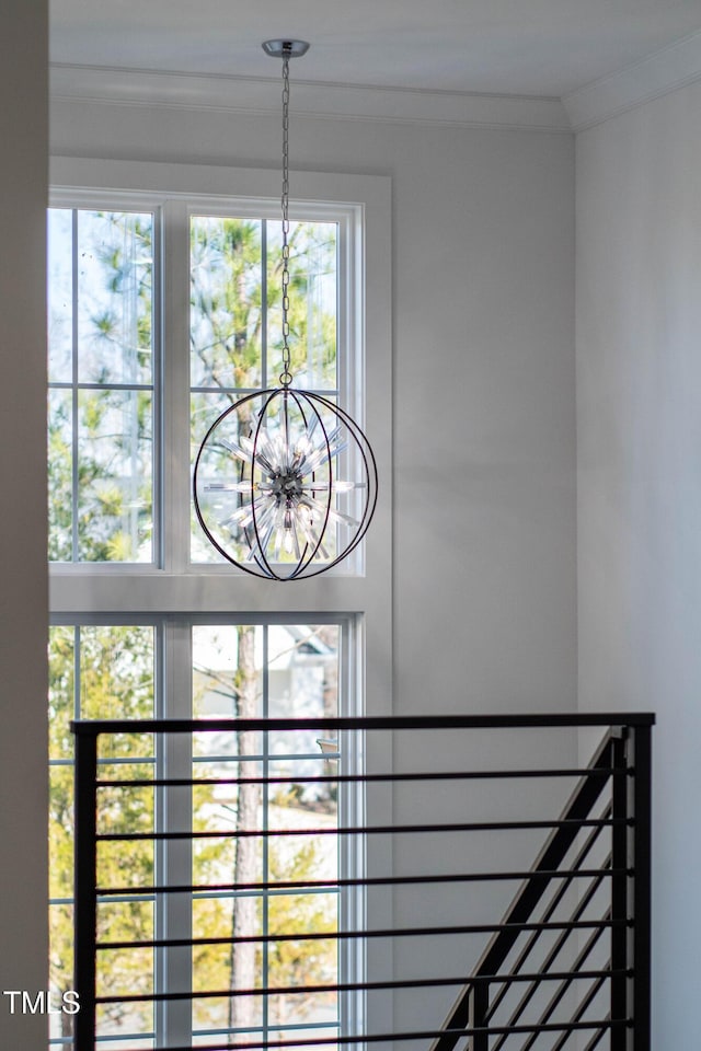 details with a notable chandelier and crown molding