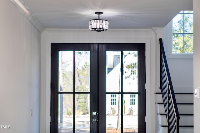 entryway featuring crown molding and french doors