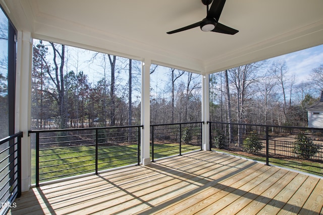 unfurnished sunroom with ceiling fan