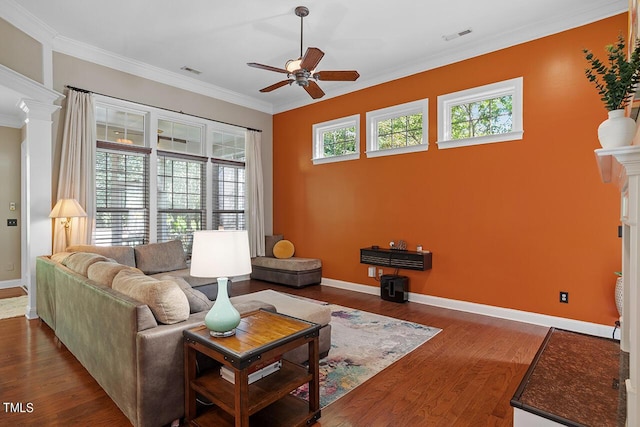 living room featuring ornate columns, crown molding, ceiling fan, and dark hardwood / wood-style floors