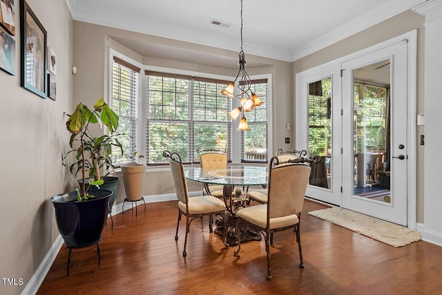 dining space featuring a wealth of natural light, dark hardwood / wood-style flooring, and a notable chandelier