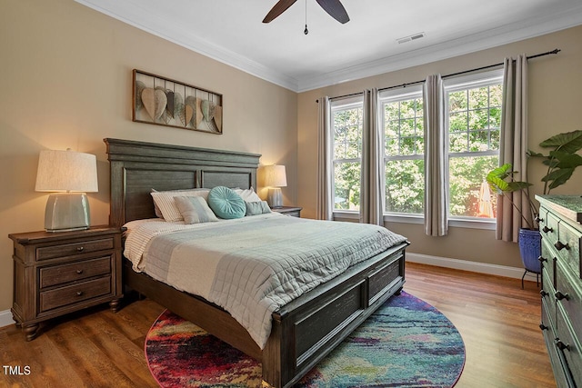 bedroom with hardwood / wood-style floors, ceiling fan, and crown molding