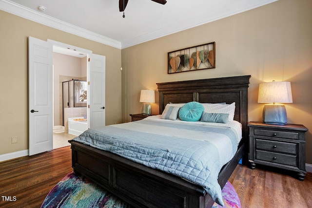 bedroom featuring ceiling fan, dark hardwood / wood-style floors, crown molding, and connected bathroom