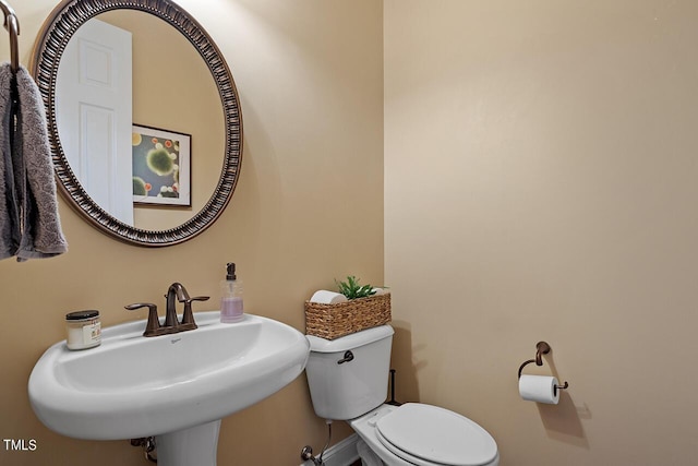 bathroom with toilet and sink