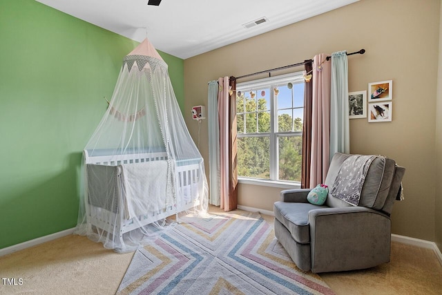 bedroom with light carpet and ceiling fan