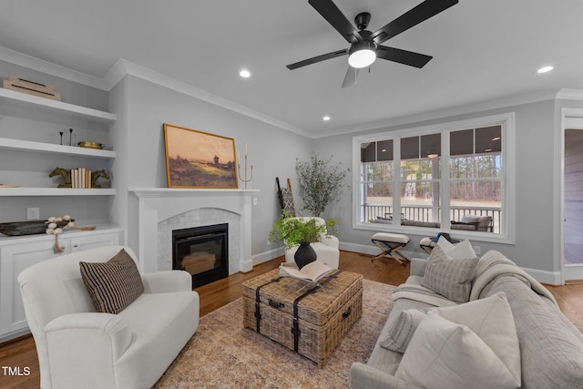 262 Hook Dr Lot 12, Fuquay Varina, NC 27526 - living area with ornamental molding, recessed lighting, a ceiling fan, a glass covered fireplace, and wood finished floors