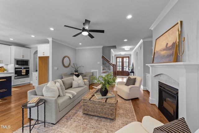 262 Hook Dr Lot 12, Fuquay Varina, NC 27526 - living area with stairs, crown molding, a glass covered fireplace, recessed lighting, and a ceiling fan