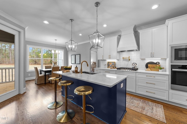 262 Hook Dr Lot 12, Fuquay Varina, NC 27526 - kitchen featuring appliances with stainless steel finishes, custom exhaust hood, a sink, ornamental molding, and a chandelier