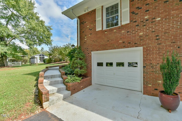 304 Homestead Rd Rd, Chapel Hill, NC 27516 - view of home's exterior with an attached garage, a yard, driveway, and brick siding