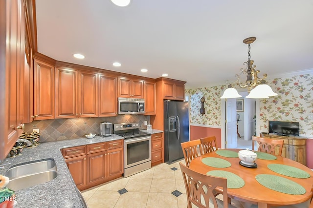 304 Homestead Rd Rd, Chapel Hill, NC 27516 - kitchen featuring appliances with stainless steel finishes, wallpapered walls, brown cabinets, tasteful backsplash, and decorative light fixtures