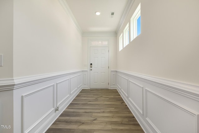 entryway with hardwood / wood-style floors and ornamental molding