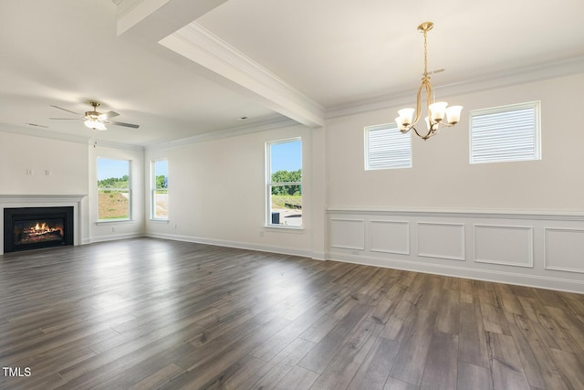 unfurnished living room featuring ceiling fan with notable chandelier, crown molding, and dark wood-type flooring