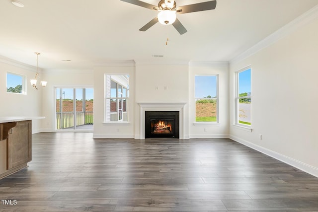 unfurnished living room featuring dark hardwood / wood-style flooring, ceiling fan with notable chandelier, and ornamental molding