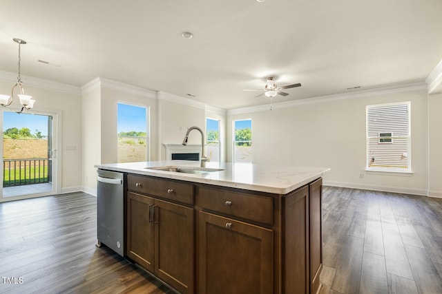 kitchen with stainless steel dishwasher, decorative light fixtures, sink, and a wealth of natural light